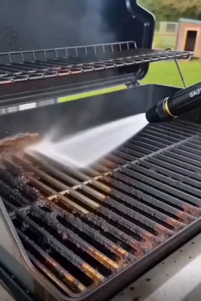 Portable pressure washer cleaning grease and grime from a BBQ grill